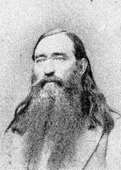 White man with long hair and beard in suit