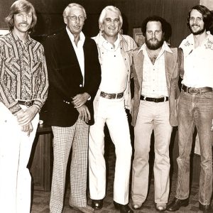 Five white men in 1970s style clothing