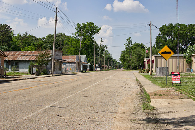 Single-story buildings and road signs on rural road