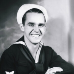 Young white man smiling in Naval uniform with cap