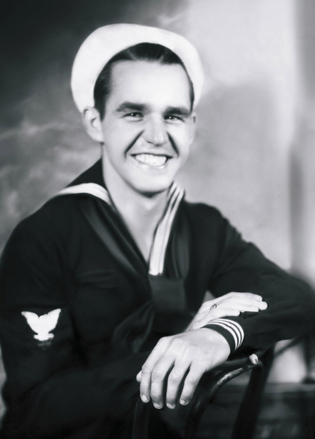Young white man smiling in Naval uniform with cap