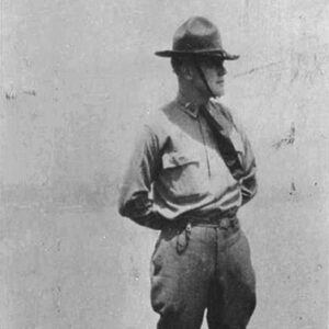 White man standing in hat and uniform