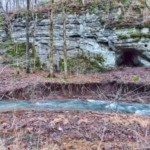 Natural rock cave and spring with rushing water