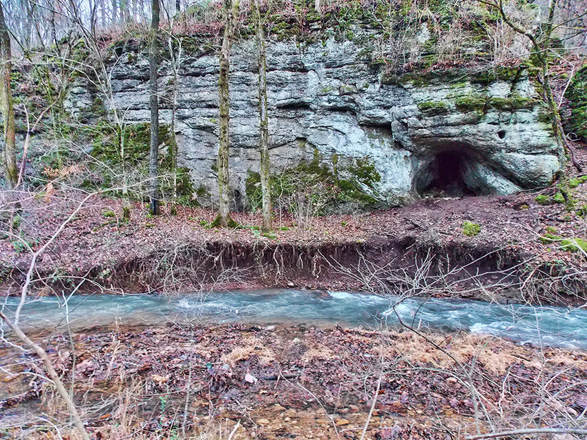 Natural rock cave and spring with rushing water