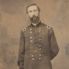 White man with beard standing in military uniform