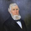 White man with long beard in suit and bow tie