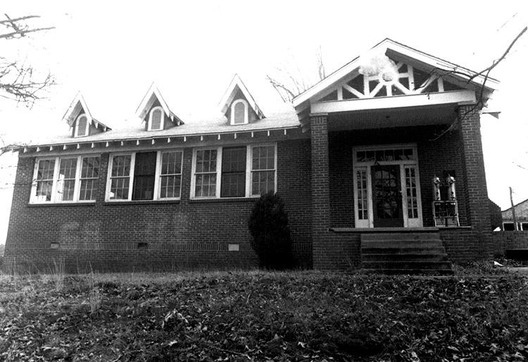 Brick school building with covered porch