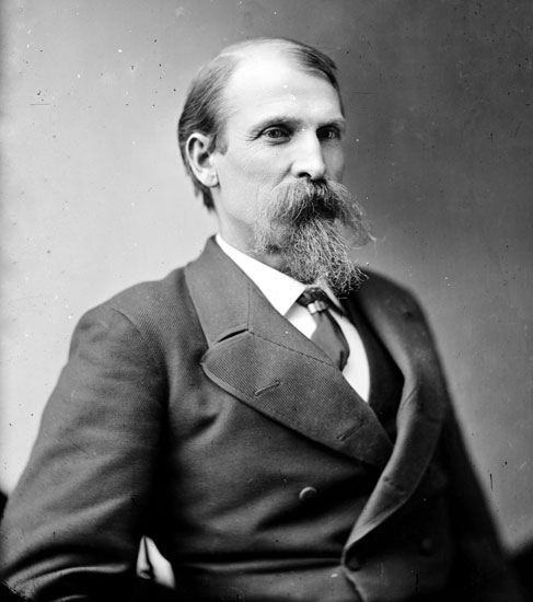 Old white man with beard in suit and tie