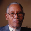 Older African-American man in glasses and suit