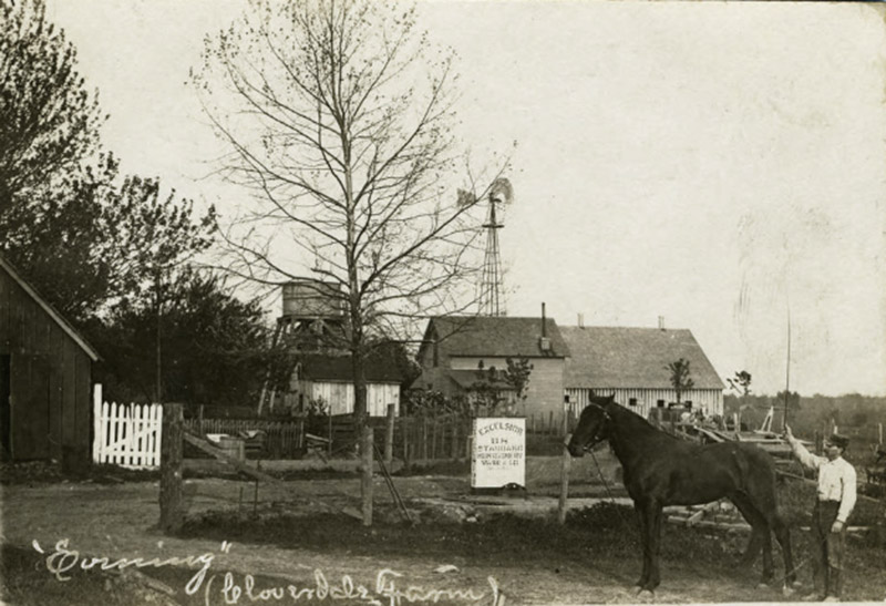 Farmer and horse with house and barns in the background