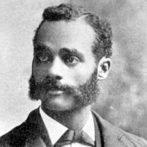 African-American man with sideburns and mustache in suit and tie