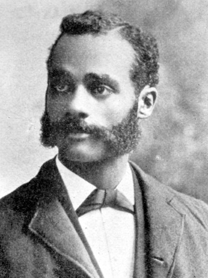 African-American man with sideburns and mustache in suit and tie