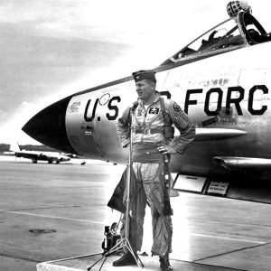 White man in pilot's uniform with cap and U.S. Air Force jet