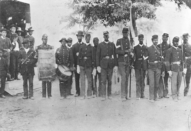 African-American soldiers in blue uniforms with guns drums and flag
