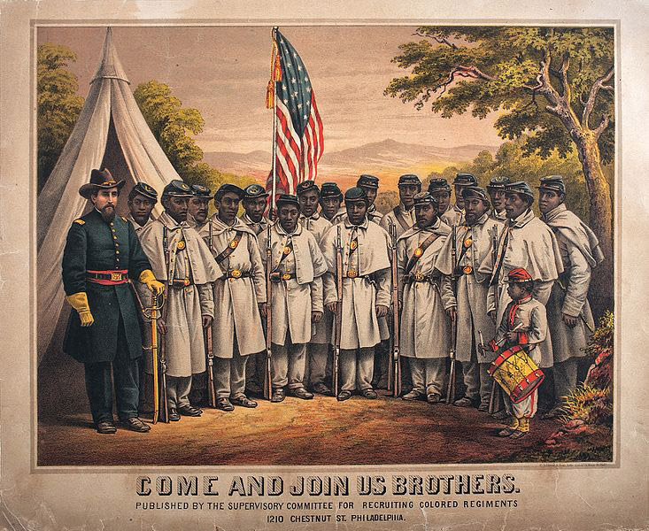 White man in blue military uniform with group of African-American men and drummer boy in uniforms at camp with flag and tent behind them