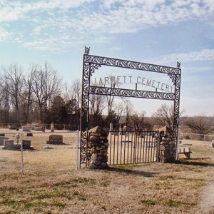 Cemetery with fence and iron gate with stone columns