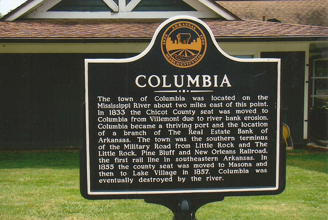 "Columbia" historical marker sign and house behind it