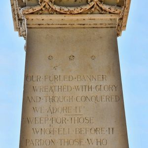 "Our furled banner wreathed with glory and through conquered we adore it" poem engraving on stone monument