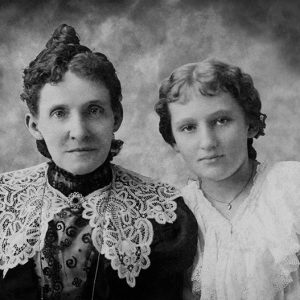 Older white woman and younger white woman in dresses with lace collars