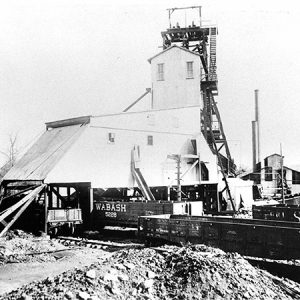 Mine buildings and train cars on tracks