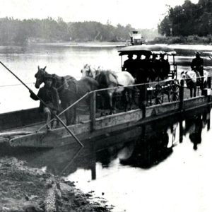 Horse drawn carriage on ferry landing on shore