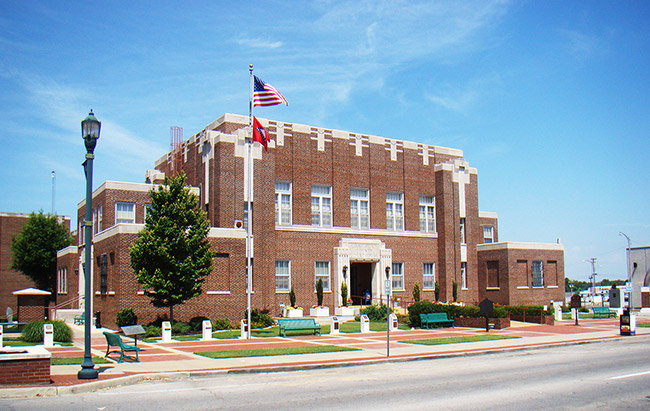 Two-story brick building with flag pole on street