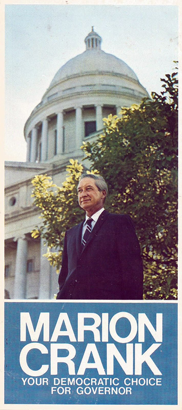 Old white man in suit and tie standing outside building with large dome