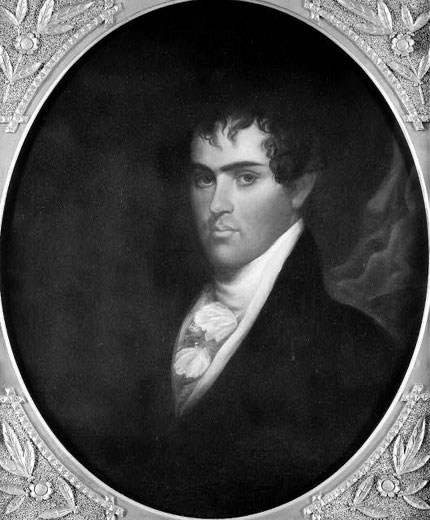 Young white man with curly hair in suit and cravat