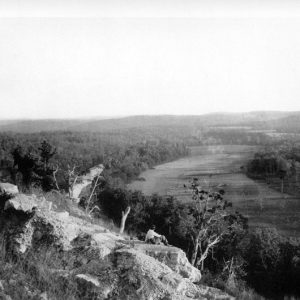 Aerial view of large creek with trees and countryside