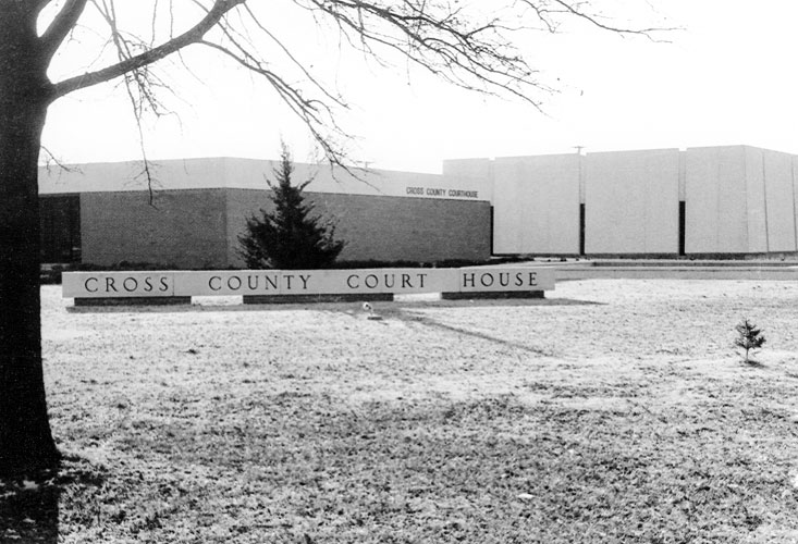 Single-story building with trees and "Cross County Court House" sign