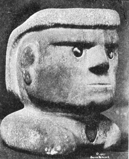 Stone sculpture with face and chest carved into it
