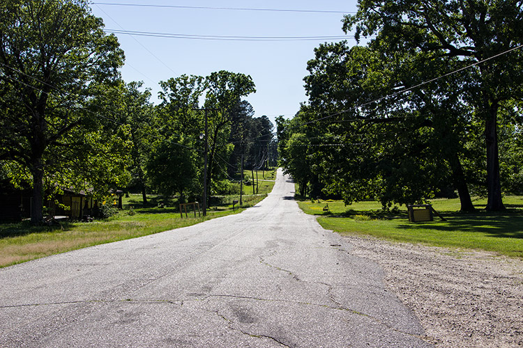Two-lane rural road through residential neighborhood