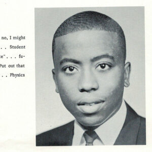 Young African-American man in suit and tie with text in yearbook