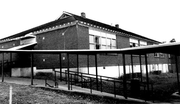 Brick school building with covered walkway with wheelchair ramp