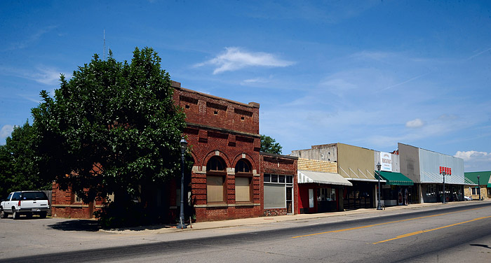Brick storefronts with awnings on multilane street