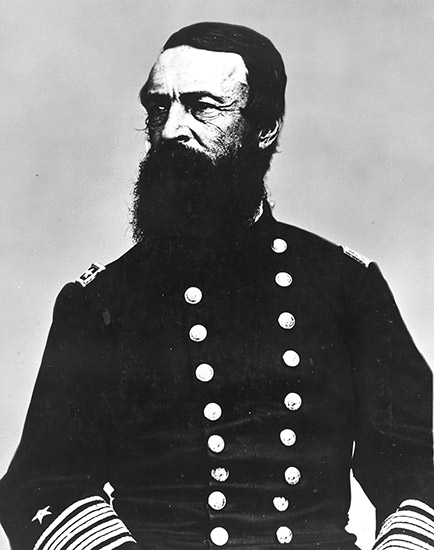 White man with bushy dark beard in military uniform