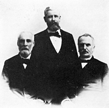 Portrait three white men in suits each with short hair and beards solemn expressions