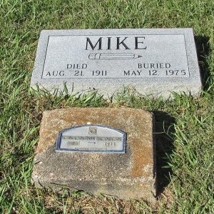 "Mike" gravestone with older gravestone in front of it