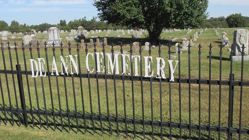 Iron fence with "De Ann Cemetery" painted on it