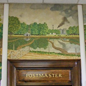 Paintings hanging in post office depicting life for African-American and white people on rice fields above "Postmaster" door