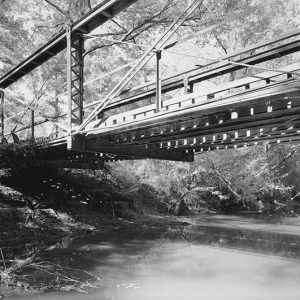 Steel arch bridge over creek