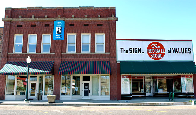 Two-story brick and single-story storefront on street