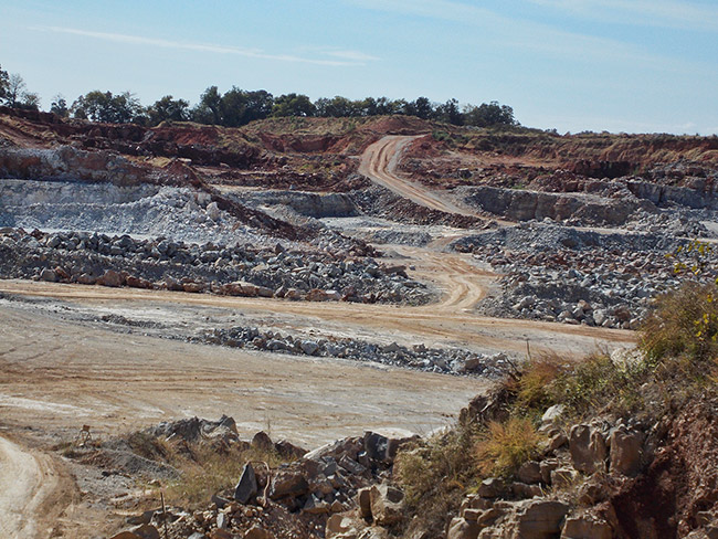 Dirt roads and quarried rocks on sloping landscape