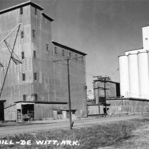 Multistory industrial buildings and silos with power lines