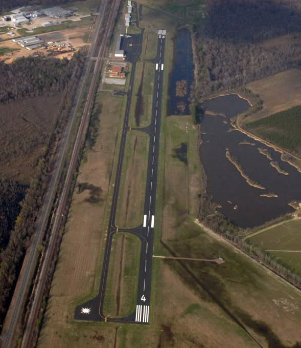 Airport runway with buildings as seen from above