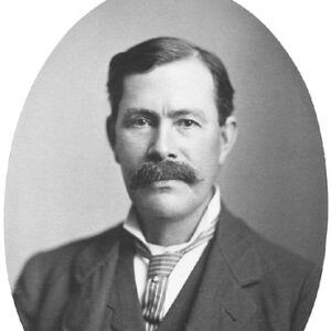 White man with mustache in suit and striped tie