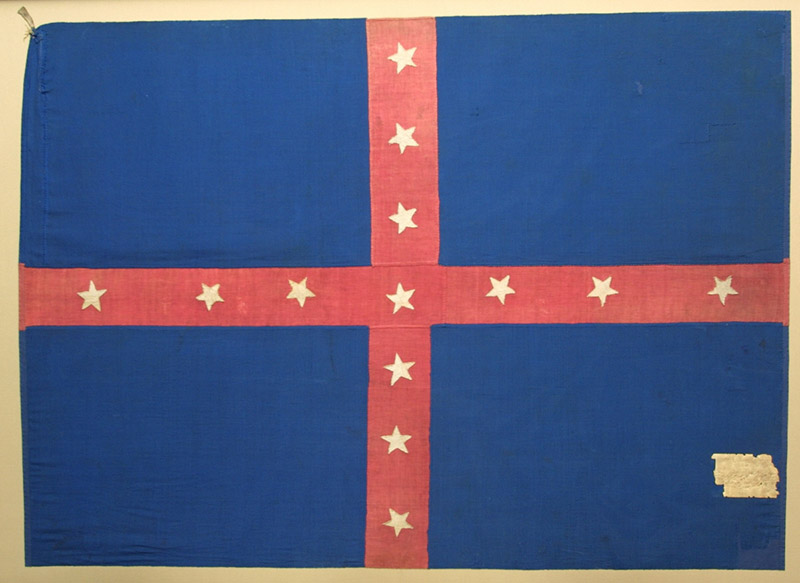 Blue flag with white stars on red cross stripes