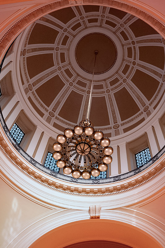 View of ceiling including dome and chandelier