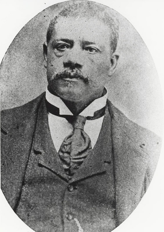 African-American man with mustache in suit and tie in oval frame