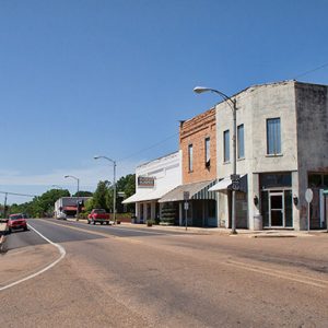 Single and multistory storefronts on two-lane street